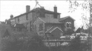 Rear view of listed Mildmay building, Eastgate St, seen from across the river with the gap on the right